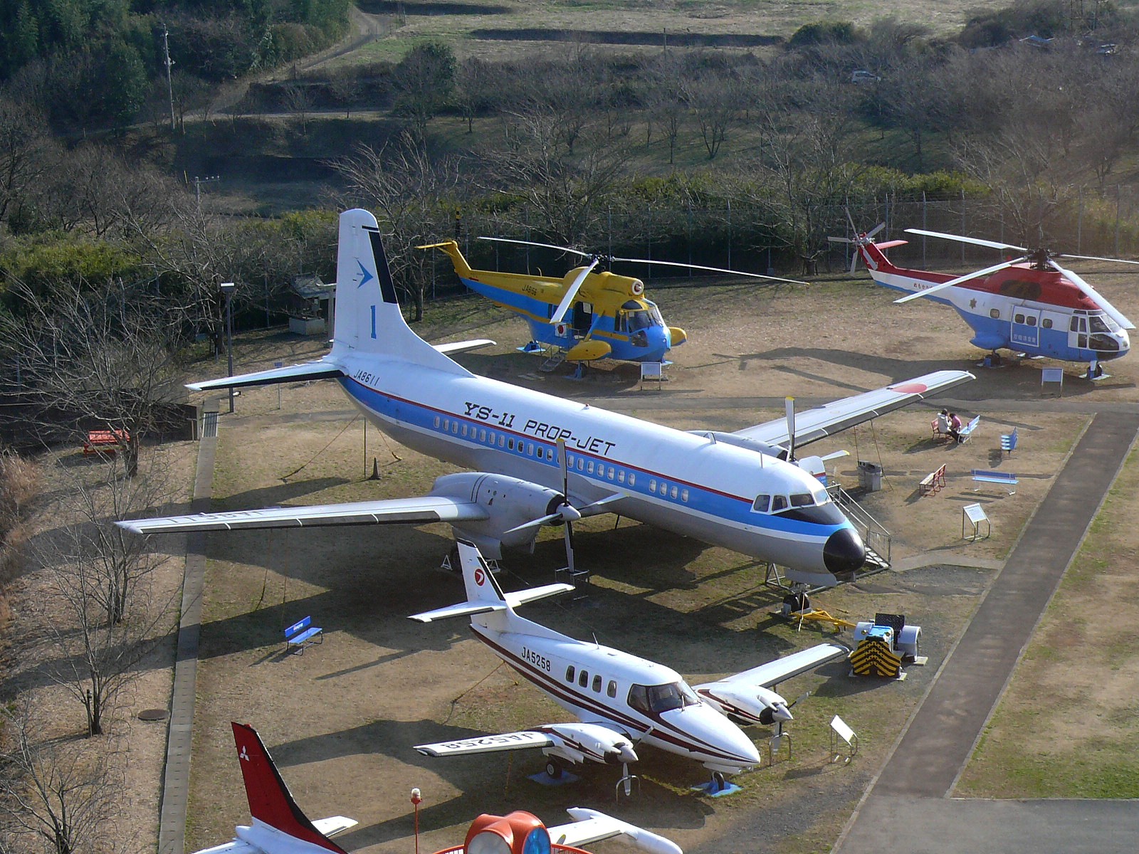 航空科学博物館の屋外展示場に並ぶYS-11旅客機とヘリコプターなどの実機