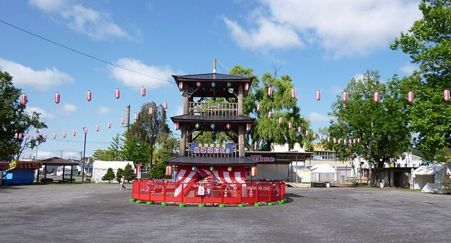 やぐらと提灯に囲まれた盆踊り会場のイメージ