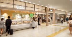 木目の格子の天井と「SIGN」の看板の下に惣菜のショーケースが並び、スーツケースを引く人などが行き交う駅構内の通路の完成予想図