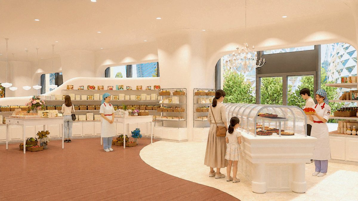 白い曲線の壁に囲まれた売り場。中央にタルトのショーケース、壁際に焼菓子の棚