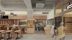 木のカウンターと棚、テーブル席が並ぶ明るい店内に、PARKLETの看板が掛かる完成イメージ図