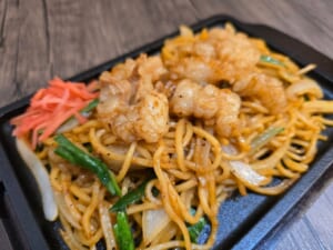 鉄板に盛った極太麺のやきそばに、ホルモン、ニラ、玉ねぎ、紅しょうが