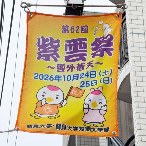 黄色地に「第62回 紫雲祭 〜雲外蒼天〜 2026年10月24日(土)25日(日)」の文字と2体のキャラクター、「鶴見大学・鶴見大学短期大学部」の表記